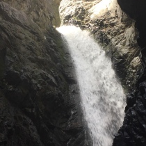 The water falls into the cave from a surface river